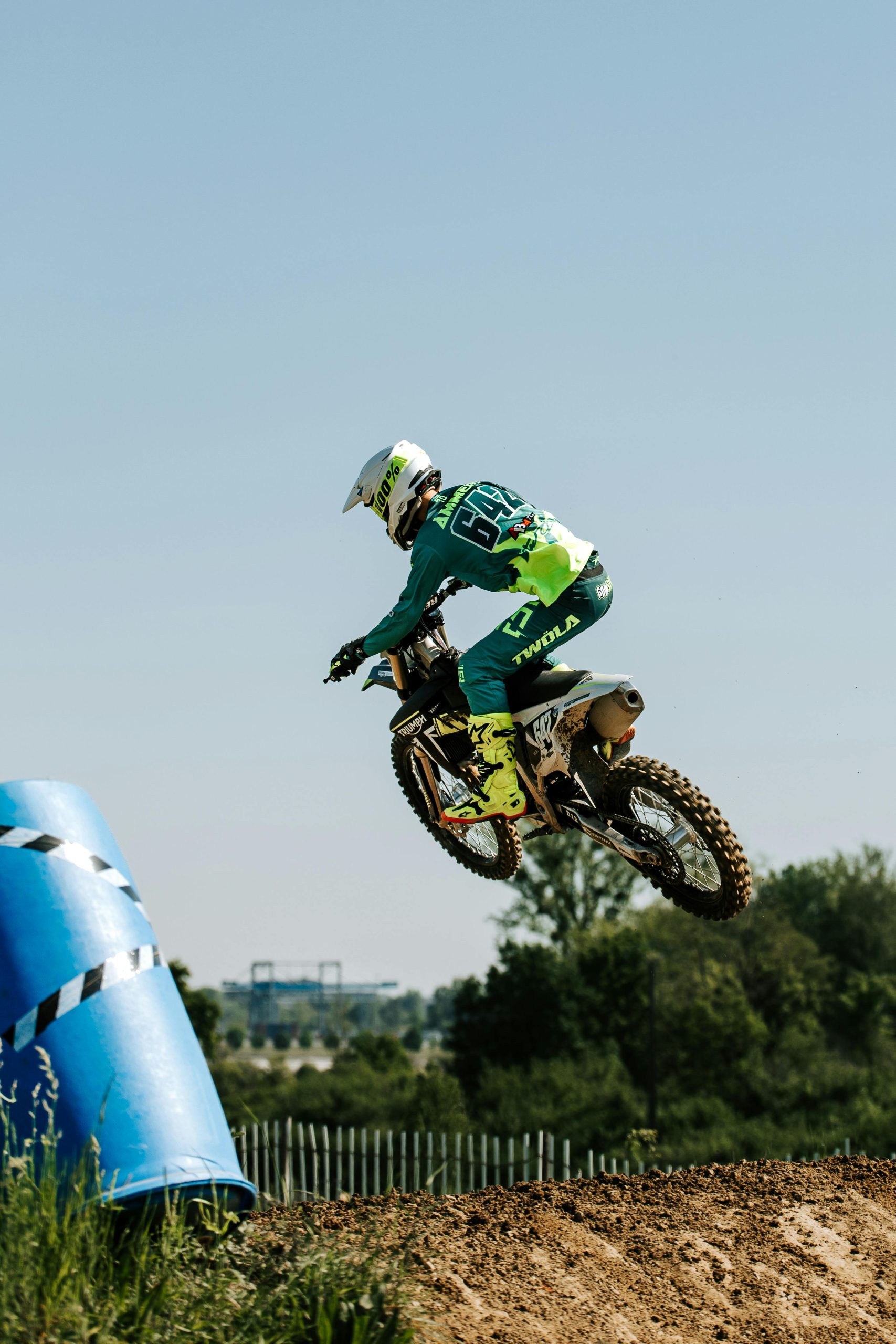 Thrilling motocross action capturé alors qu'un pilote saute haut lors d'une compétition de sport motorisé en plein air.